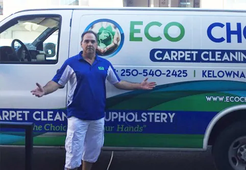 An Eco Choice owner beside the company’s carpet cleaning van